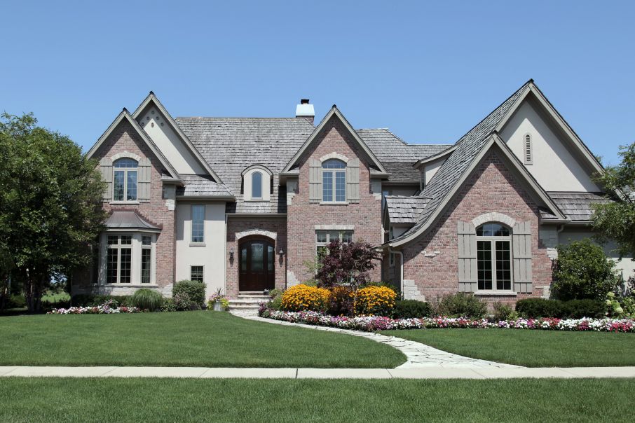 Stone Sided Gray Hip Roof Home
