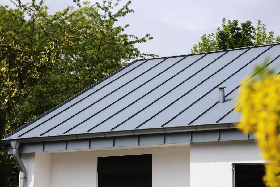 Medium Mansard Roof with Standing Seam Material Shines in the Sun