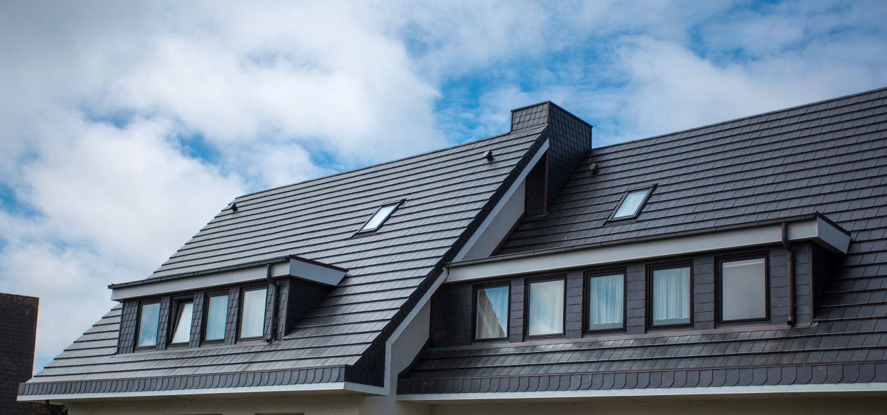 Medium-sized Roof with Glimmering Shingles and Clear Blue Sky