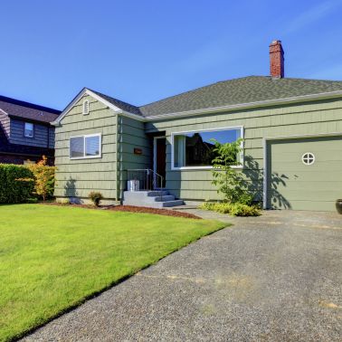 This small house is a great example of a cozy home. It has a green shingle siding that gives it a classic look. The size of the house is small making it perfect for a family of four or less. It is a single-family house so you don't have to worry about sharing walls with neighbors. The green color of the siding gives the house a warm and inviting feel.