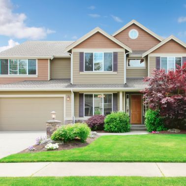 This medium-sized house has a hip roof with gray shingles. The exterior is clad in clapboard siding giving it a classic look. The house is a single-family dwelling with plenty of room for a family to live comfortably. The hip roof and clapboard siding give the house a timeless look that will never go out of style.